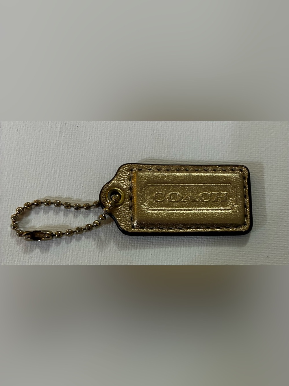 Coach EUC Metallic Gold Leather hang tag/ Keychain @2”